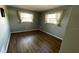 Bedroom with wood floors and two windows at 4250 Shamrock Dr, Venice, FL 34293