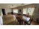 Bright dining room features a wood table, wood floors, and large windows at 4250 Shamrock Dr, Venice, FL 34293