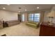 Living room with carpet, couches, and a window at 4250 Shamrock Dr, Venice, FL 34293