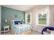 Charming bedroom featuring unique wall decor, a comfortable bed, and natural light from the window at 25497 Calusa Dr, Punta Gorda, FL 33955