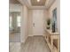 Welcoming entryway featuring a stylish console table, modern decor, and a glimpse into the adjacent bedroom at 25497 Calusa Dr, Punta Gorda, FL 33955