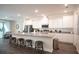 Modern kitchen with white cabinets, stainless steel appliances, granite countertops and stools at the island at 25497 Calusa Dr, Punta Gorda, FL 33955