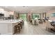 Modern kitchen and living room feature white cabinets, stainless steel appliances, marble countertops and stylish furniture at 25497 Calusa Dr, Punta Gorda, FL 33955