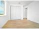 Spacious bedroom with wood-look tile flooring and double door closet at 15245 Brainbridge Circle, Port Charlotte, FL 33981