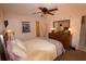 Bright bedroom with a queen-size bed and ensuite dresser at 1104 S Moonmist Ct # M-10, Sarasota, FL 34242