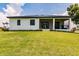 Back view of a house with a screened-in porch at 24194 Peppercorn Rd, Punta Gorda, FL 33955