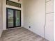 Modern front entry with double glass doors and gray tile flooring at 24194 Peppercorn Rd, Punta Gorda, FL 33955