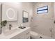Modern bathroom with marble shower and white vanity at 24194 Peppercorn Rd, Punta Gorda, FL 33955