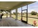 Relaxing screened porch overlooking a lush green landscape at 24194 Peppercorn Rd, Punta Gorda, FL 33955