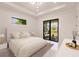 Spacious bedroom with king bed and access to outdoor patio at 24194 Peppercorn Rd, Punta Gorda, FL 33955