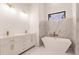 Spa-like bathroom with double vanity, soaking tub, and marble finishes at 24194 Peppercorn Rd, Punta Gorda, FL 33955