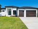 Modern home with two-car garage and nicely landscaped front yard at 24194 Peppercorn Rd, Punta Gorda, FL 33955
