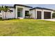 Modern two-story home with a two-car garage and beautifully landscaped yard at 24194 Peppercorn Rd, Punta Gorda, FL 33955