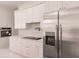 Modern kitchen with white cabinets, stainless steel appliances, and a large island at 24194 Peppercorn Rd, Punta Gorda, FL 33955
