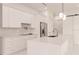 Modern kitchen with white cabinets, stainless steel appliances, and a large island at 24194 Peppercorn Rd, Punta Gorda, FL 33955