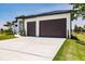 Modern home with two-car garage and a spacious driveway at 24194 Peppercorn Rd, Punta Gorda, FL 33955