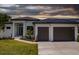 Modern home with a two car garage, and a landscaped front yard at 24194 Peppercorn Rd, Punta Gorda, FL 33955