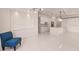 Bright and airy living room with open floor plan and blue accent chair at 24194 Peppercorn Rd, Punta Gorda, FL 33955