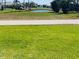 Homes bordering a pond with lush green grass at 24194 Peppercorn Rd, Punta Gorda, FL 33955