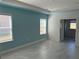 A bedroom featuring bright window views and tile flooring; door leads to additional space at 25491 Calusa Dr, Punta Gorda, FL 33955