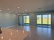 Bright, open living room with tile flooring, recessed lighting, and sliding glass doors to the backyard at 25491 Calusa Dr, Punta Gorda, FL 33955
