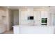 Modern kitchen with white cabinets, quartz counters, and island at 25491 Calusa Dr, Punta Gorda, FL 33955