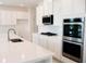 Spacious kitchen with white cabinets and stainless steel appliances at 25491 Calusa Dr, Punta Gorda, FL 33955