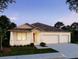 Charming single-story home featuring a spacious two-car garage, neutral color palette, and well-manicured lawn at 27092 Formosa Dr, Punta Gorda, FL 33983