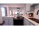 Open concept kitchen with view of living area, light blue cabinets, and quartz countertops at 922 E Ida St, Tampa, FL 33603