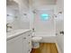 Clean bathroom featuring a white vanity, shower/tub combo, and wood floors at 865 Everest Rd, Venice, FL 34293