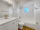 Updated bathroom with white vanity, bathtub, and wood-look floors at 865 Everest Rd, Venice, FL 34293