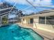 Inviting pool area with screened enclosure, spa, and ample patio space at 865 Everest Rd, Venice, FL 34293