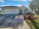House exterior showcasing a driveway and landscaped yard at 865 Everest Rd, Venice, FL 34293