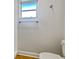 Simple bathroom with toilet, shower, and window at 865 Everest Rd, Venice, FL 34293