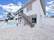 Backyard featuring a pool, patio, and stairs leading to a screened porch, designed for relaxation and entertainment at 7438 Gulf Way, Hudson, FL 34667