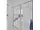 Modern bathroom with glass-enclosed shower, soaking tub, and white tile at 7438 Gulf Way, Hudson, FL 34667