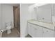 Bathroom with a glass shower door, granite countertop, and a large mirror at 7438 Gulf Way, Hudson, FL 34667