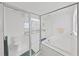 Bright bathroom featuring glass shower, soaking tub, and neutral tiling at 7438 Gulf Way, Hudson, FL 34667