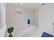 Bright white bathroom features a soaking tub, walk-in shower and blue accents at 7438 Gulf Way, Hudson, FL 34667