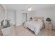Comfortable bedroom with wood-look floors, ceiling fan, closet, and neutral decor at 7438 Gulf Way, Hudson, FL 34667