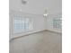 Inviting bedroom with tile floors, two windows, and abundant natural light at 7438 Gulf Way, Hudson, FL 34667