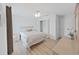 Bright bedroom featuring neutral colors, a ceiling fan, and wood-look floors at 7438 Gulf Way, Hudson, FL 34667
