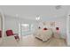 Cozy bedroom with a private balcony, ceiling fan, and neutral decor at 7438 Gulf Way, Hudson, FL 34667