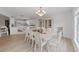 Open-concept dining room with light wood floors and view of kitchen at 7438 Gulf Way, Hudson, FL 34667