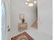 Elegant foyer with a decorative chandelier, a wooden staircase and a decorative chest at 7438 Gulf Way, Hudson, FL 34667