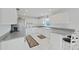 Bright kitchen features white cabinets, stainless appliances and breakfast bar at 7438 Gulf Way, Hudson, FL 34667