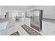 Clean, bright kitchen with stainless fridge and view to dining area at 7438 Gulf Way, Hudson, FL 34667