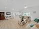 Open living room with vaulted ceiling, natural light, and comfortable seating at 7438 Gulf Way, Hudson, FL 34667