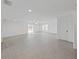 Bright living room with tiled flooring, a ceiling fan, and sliding glass doors that lead to the outdoor patio area at 7438 Gulf Way, Hudson, FL 34667