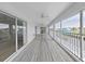 Spacious screened-in patio with waterfront views and access to the indoors at 7438 Gulf Way, Hudson, FL 34667